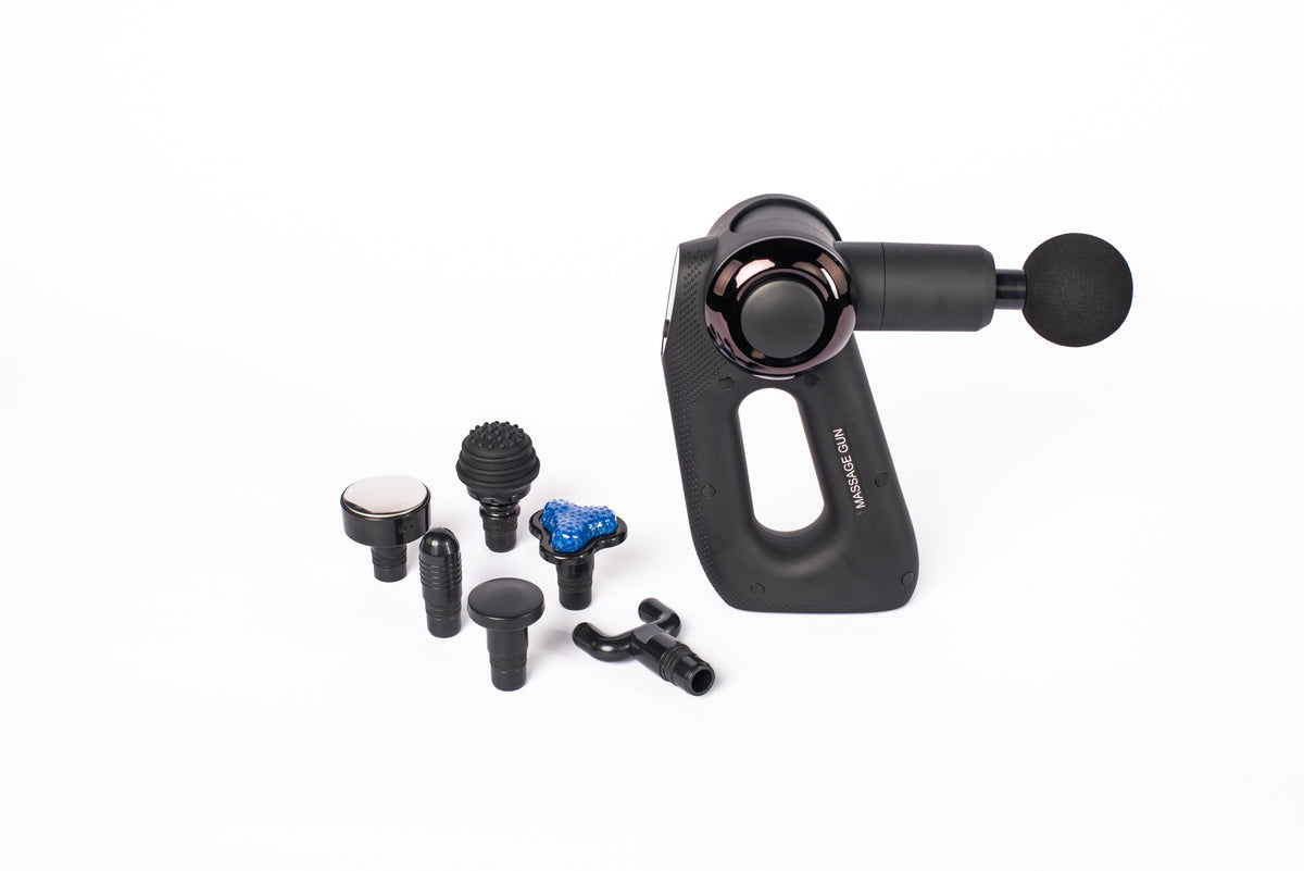 Massage gun shown with its attachment heads on a white background